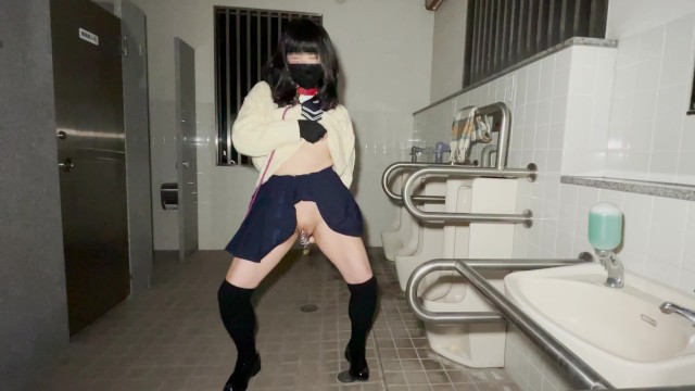 A high school girl wearing a chastity piercing masturbates anally in a men's public restroom.
